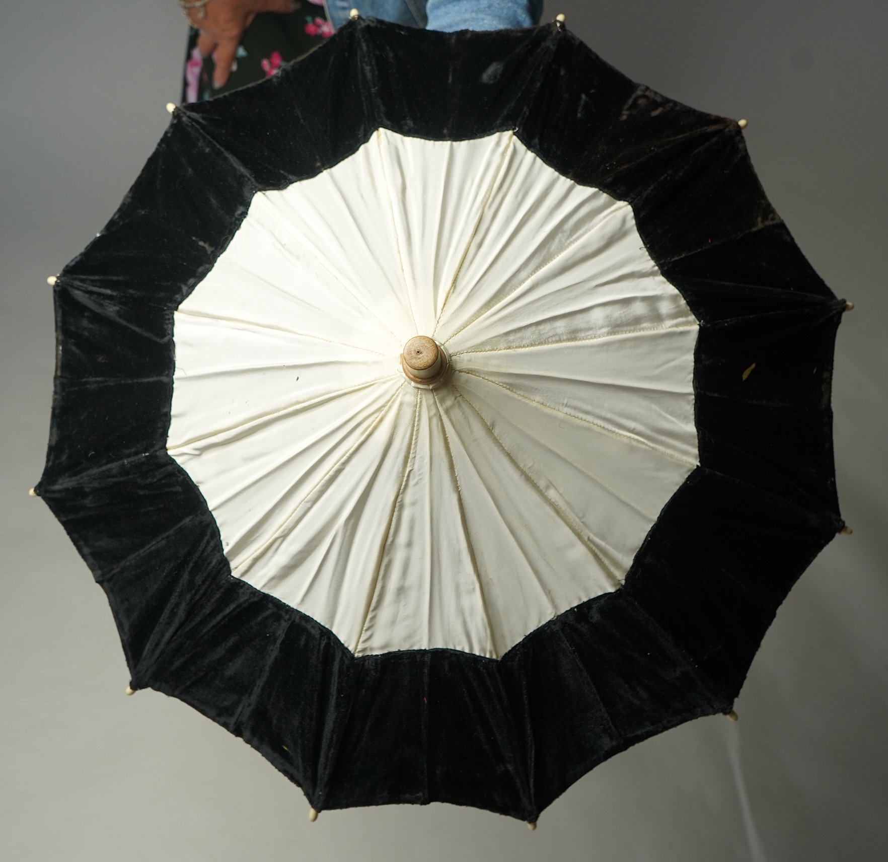An unusual early 20th century cream silk and black velvet parasol and silk corded tassel. 64cm high. Condition - good